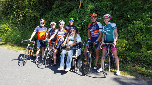 Ian posing next two 6 team members on bikes