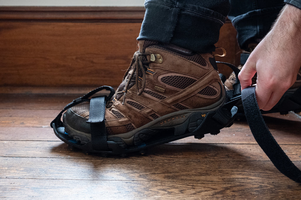 putting on ice cleats on shoes