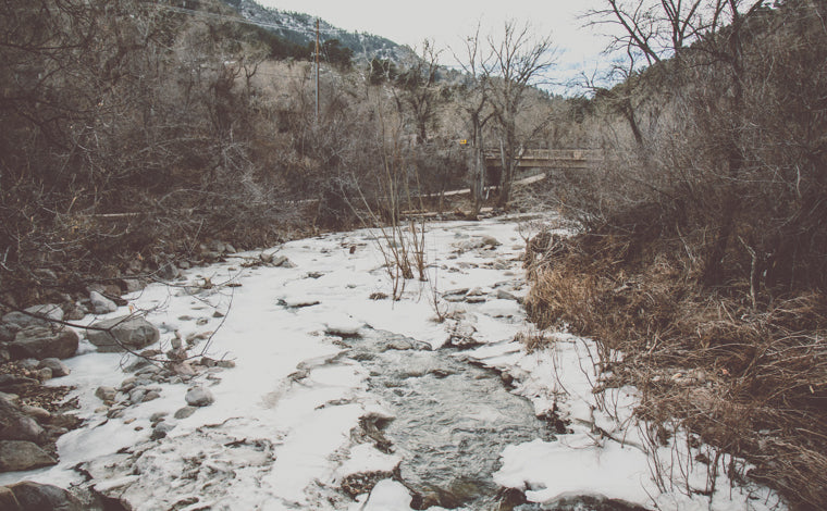 Photo of frozen boulder creek in winter