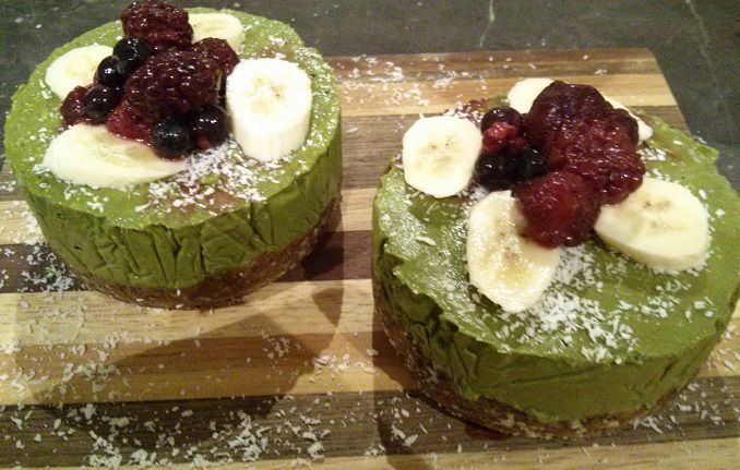 two matcha cakes on chopping board with coconut