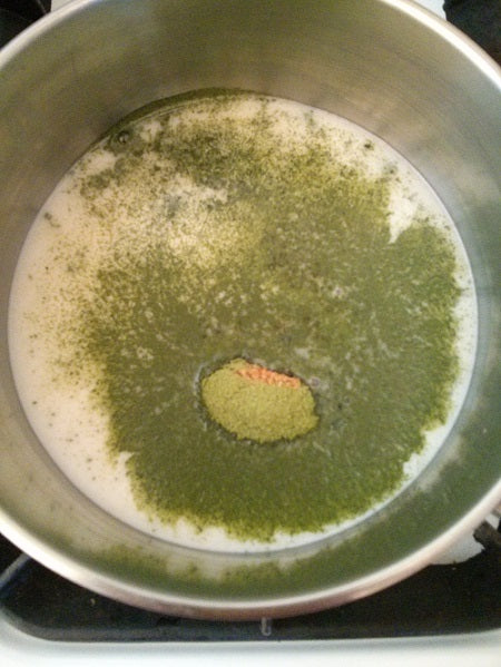 Making a hot green tea latte on the stove top