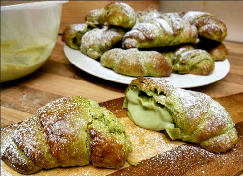 Homemade freshly baked matcha croissant filled with luscious bittersweet matcha green tea cream filling, served for breakfast or brunch