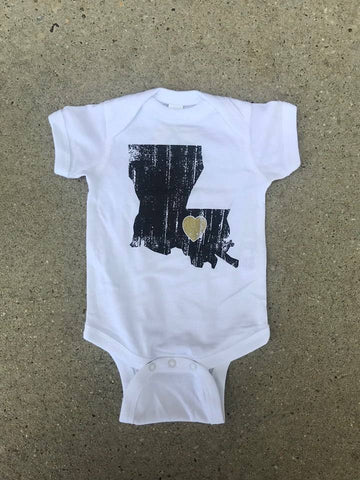 This Louisiana Love Onesie from Fleurty Girl is a white onesie featuring an image of the state of Louisiana in black with a gold heart over the place where New Orleans lies on the map.