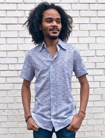 This Light Blue Ikat Men's Button Down Shirt from Passion Lilie features short sleeves, a light blue woven cotton, and a fitted silhouette, making it one of the Valentine's Day clothing gifts he'll love.