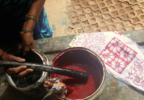 Red and black natural dyes, such as those shown here, are used along with a variety of other colors in Passion Lilie's Indian clothing.