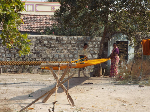 Two of our fair trade artisans from India are pictured here hanging fabric to dry, helping to reduce our environmental footprint.