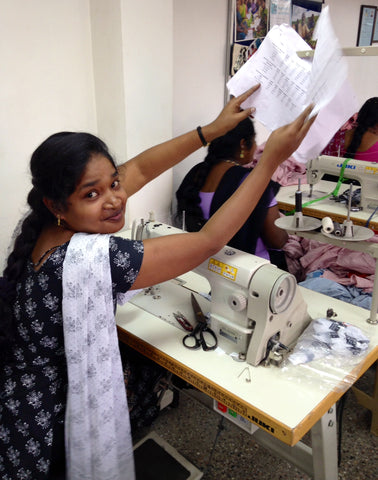 Fair trade stitcher at a sewing cooperative.