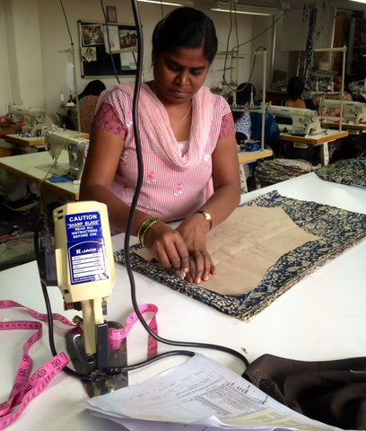 Fair trade workshop- artisan cuts the pattern pieces