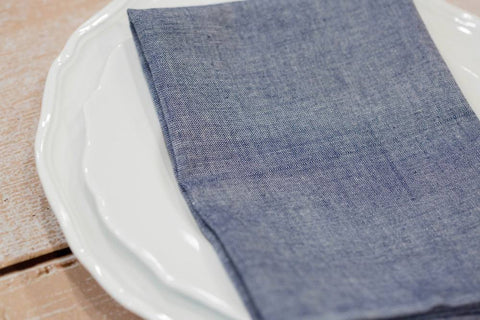 Cloth napkins, such as this Chambray Cloth Napkin from Passion Lilie, are a must when planning a sustainable dinner party.