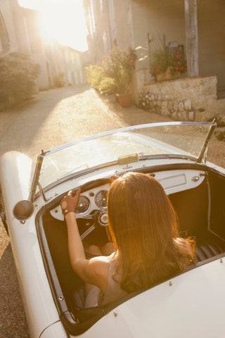 Luxury vintage convertible Car woman road trip alone