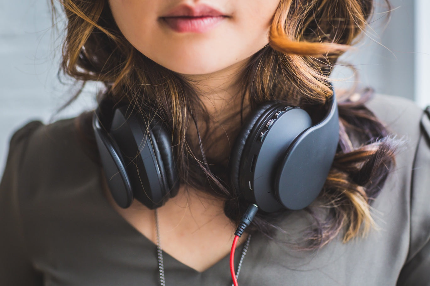 Woman with headphones around neck