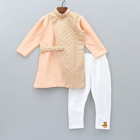 Pre Order: Peach Embroidered Sherwani And White Churidar