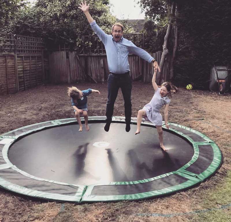 dad on trampoline with kids
