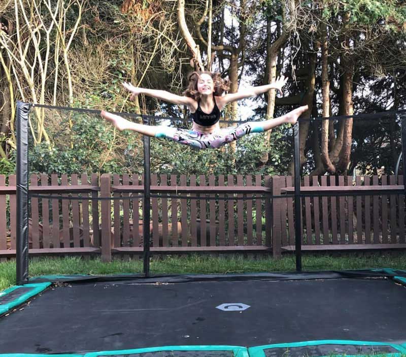 Gymnast on trampoline in ground