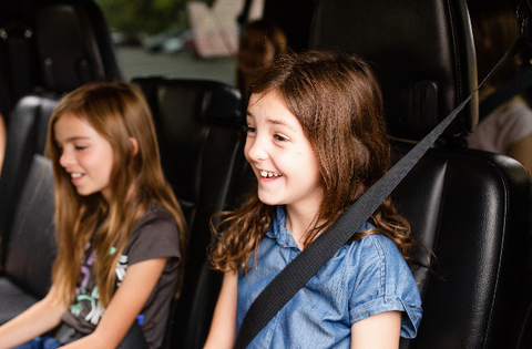 Two young kids play the family conversation starter game on the way to school in the car