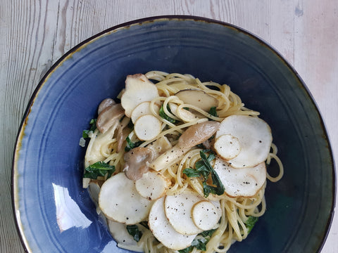 Mushroom pasta with ramson and jerusalem artichokes in a bowl