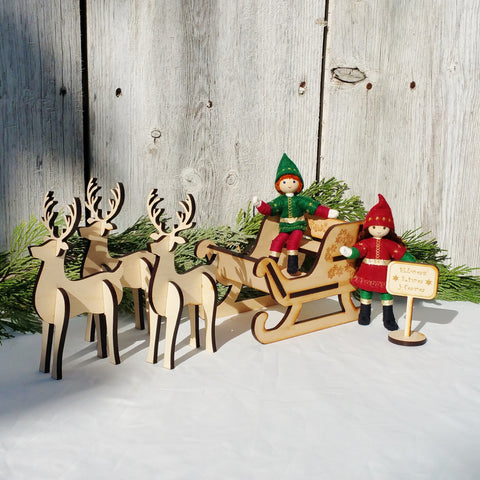 Kindness Elves in Santa's sleigh with wooden reindeer