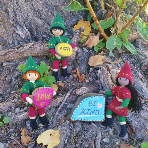 The kindness elves placing word rocks around town