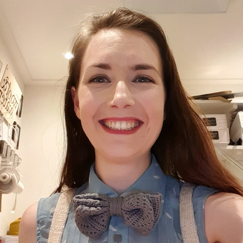Smiling Girl in Knitted Bow Tie and Suspenders