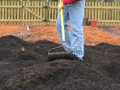 Raking in Biochar for Veggie Garden