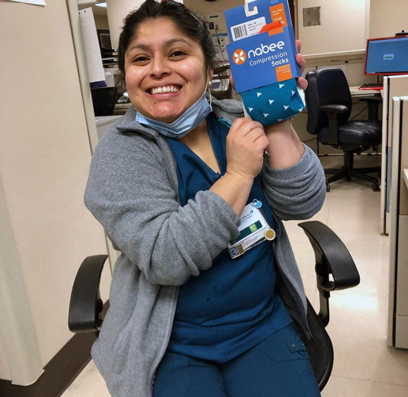 Nurse holding a pair of Nabee Socks Compression Socks