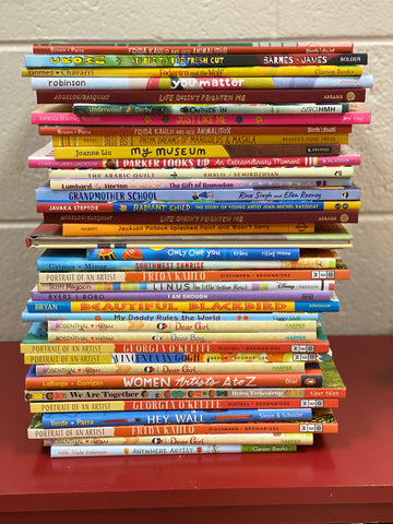 stack of thin books on a red table