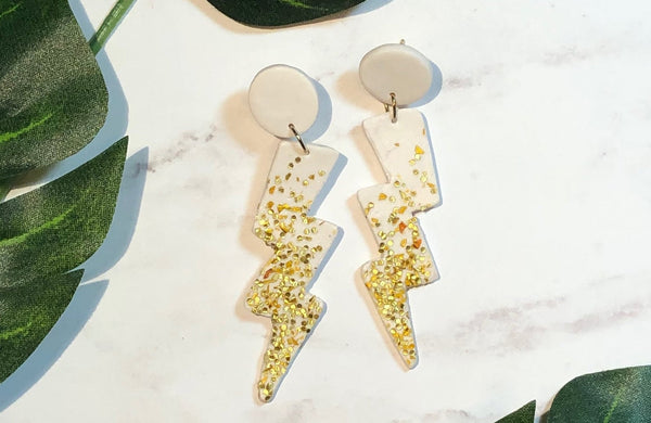 lightning shaped earings with gold glitter