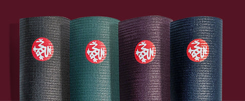 Four PRO yoga mats (Thunder, Lotus, Indulge & Midnight colours) standing vertically side by side - MANDUKA | Eco Yoga Store