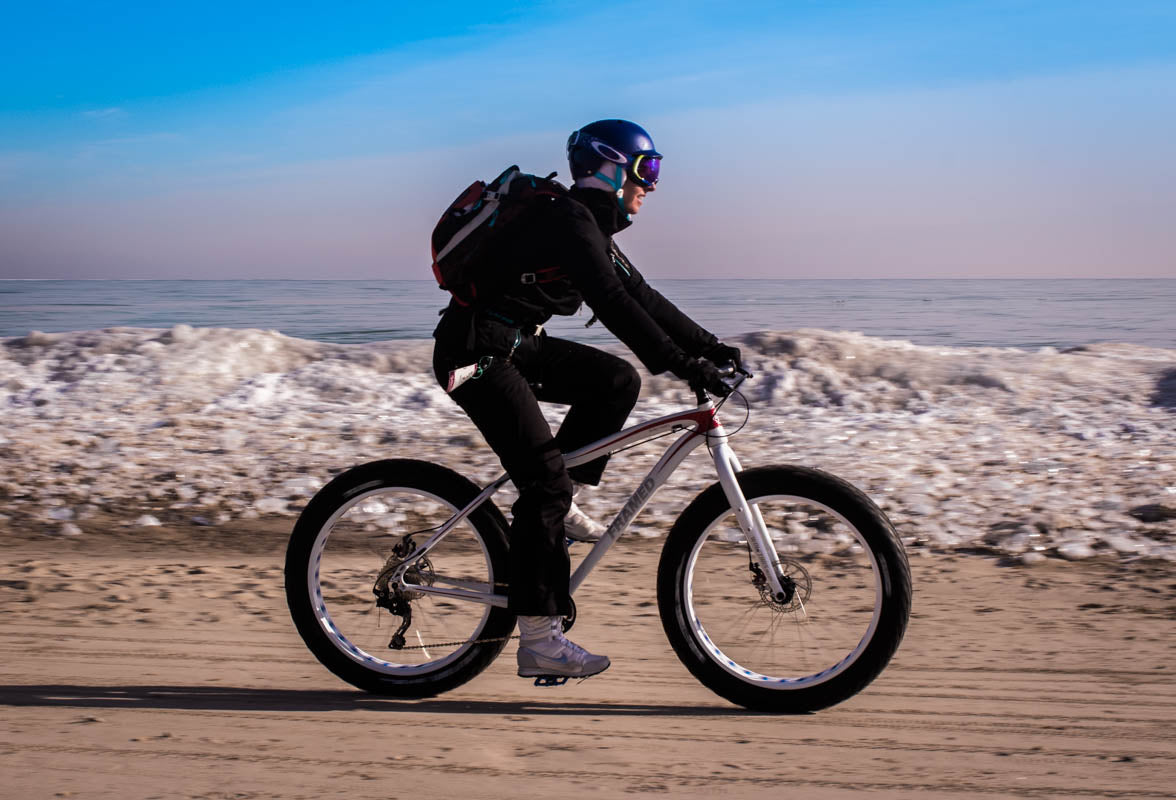 Rolling the sandy beach on a Framed fat bike rented at Fyxation