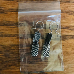 Patina'd (chemically blackened) sterling silver. earrings and resealable zip lock bag