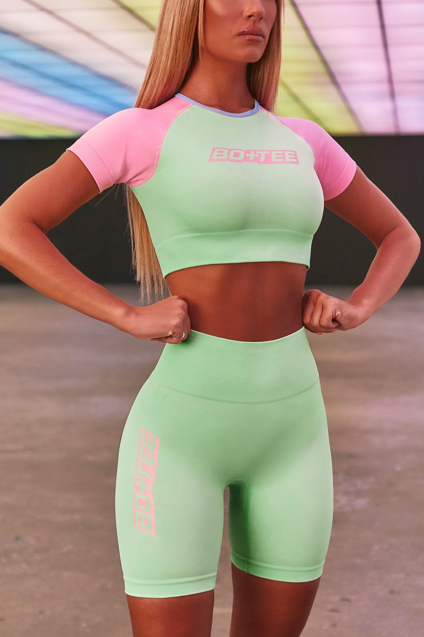 Lime green seamless high waisted cycling shorts with 3D branding down the leg. Image 2 of 6.