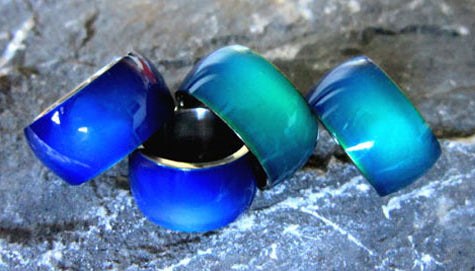 stainless steel band mood rings turning a blue color taken on a rock