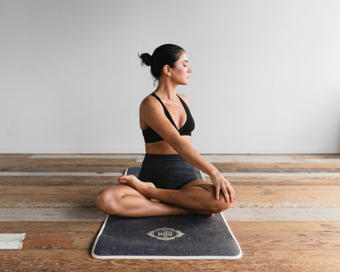 woman doing yoga on a yoga mat