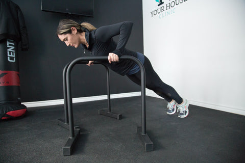 Woman doing a push-up on rails