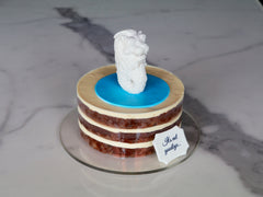 Carrot naked cake layered with cream cheese, topped with a handmade Singapore merlion fondant figure