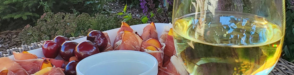 prosciutto wrapped grilled peaches and a glass of white wine