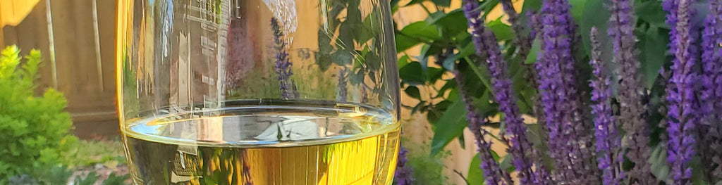 glass of white wine with lavendar flowers