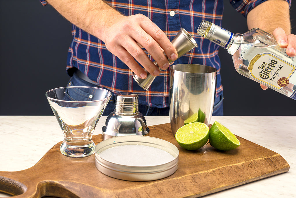 Person Pouring 2oz tequila in a Boston cocktail shaker. 