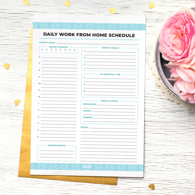 An image of the Daily Work From Home Schedule printable printed on paper, sitting on a desk