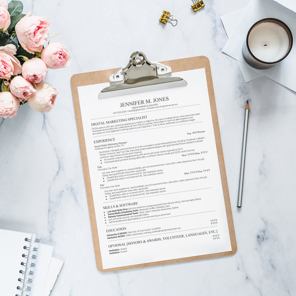 Resume template on a clipboard sitting next to a base of roses 