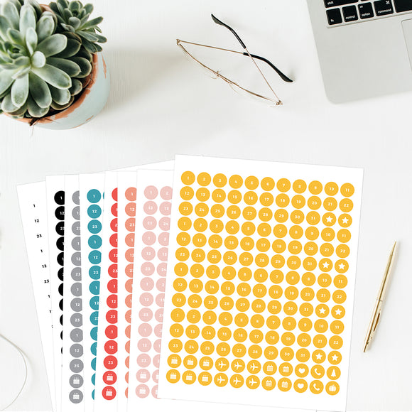 8 Date Dots Printables printed on circular Avery sticker paper, including Numbers 1 through 31, stars, birthday cakes, airplanes, calendars, hearts, phones, and holiday-themed stickers