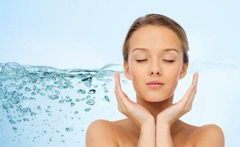 woman in artistic picture with a splash of water showing a hydrated face