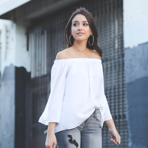 Off-Shoulder-Top-with-Ripped-Denims-with-statement-earrings