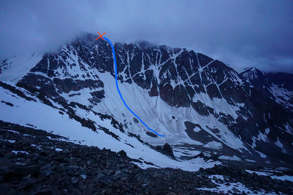 A view of Granite Peak under stormy skies with a red X near the summit marking the site of Eiten's accident.