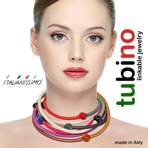 Model wearing multiple TUBINO MURANO linkable BRACELETS in array of fashion colors, luxurious hypoallergenic synthetic rubber with handmade murano glass links, easily cut to size, Made in Italy