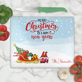 glass cutting boards with gnome elves with gift sled personalized with any name on bottom. Top says Merry Christmas and Happy New Year in Stylish font combination