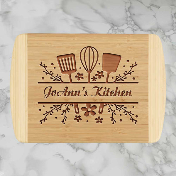 Engraved Spatula Wisk and Sliced Spatula with your name  in a decorative border on a wood 2 tone cutting board
