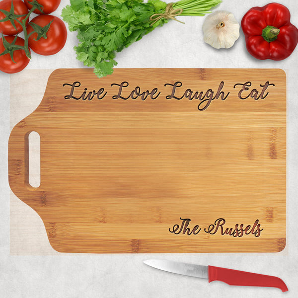 Bamboo cutting board with extension for slotted handle and Live Love Laugh Eat engraved along the top. Any name on the bottom right.