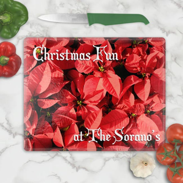 Full background of Poinsettias on a tempered glass cutting board in two sizes and any text personalized on top left an d bottom right