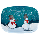 two snowmen on a snowy hill with trees and snow falling in the background.. Two areas of personalization.